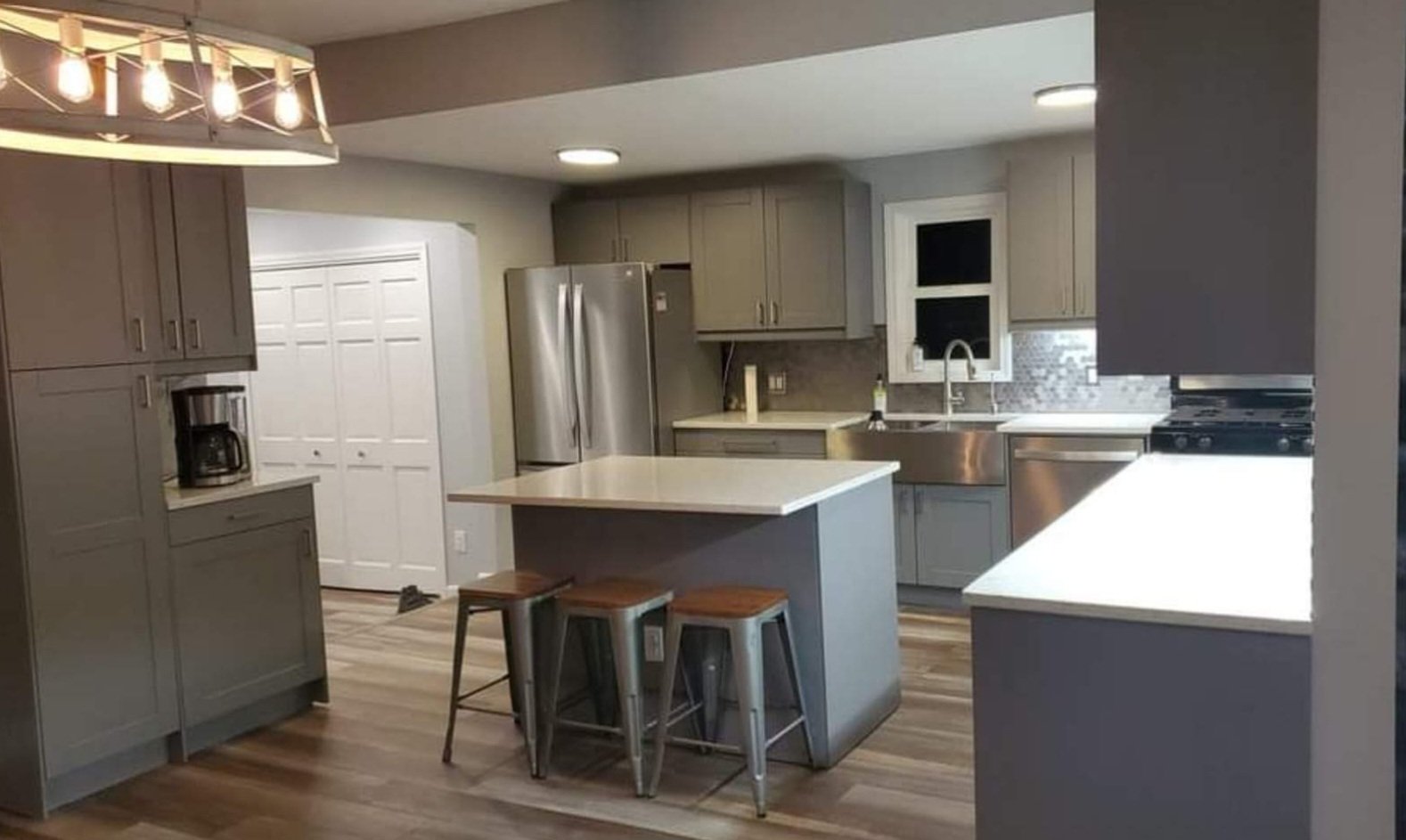 Completed kitchen remodel with gray cabinetry and a center island